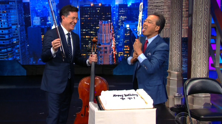 Yo-Yo Ma cuts his birthday cake, and licks the bow on Stephen Colbert's Late Show, Oct. 5, 2015.