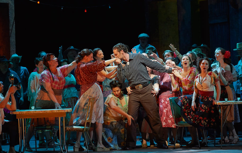Christian Van Horn as Escamillo (centre) and Sasha Djihanian as Frasquita (right, at table) in the Canadian Opera Company production of Carmen, 2016, (Photo: Michael Cooper)