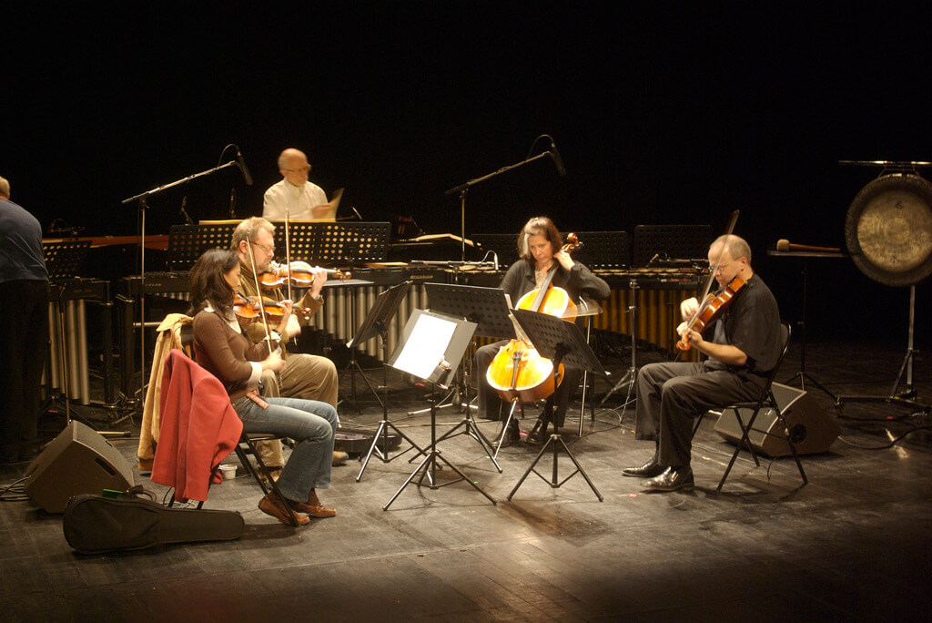 Steve Reich Ensemble playing Different Trains (from left to right) Liz Lim-Dutton, violin, Todd Reynolds, violin, Jeanne LeBlanc, cello, Scott Rawls, viola, Russ Hartenberger at the back (Photo: Flickr.com)