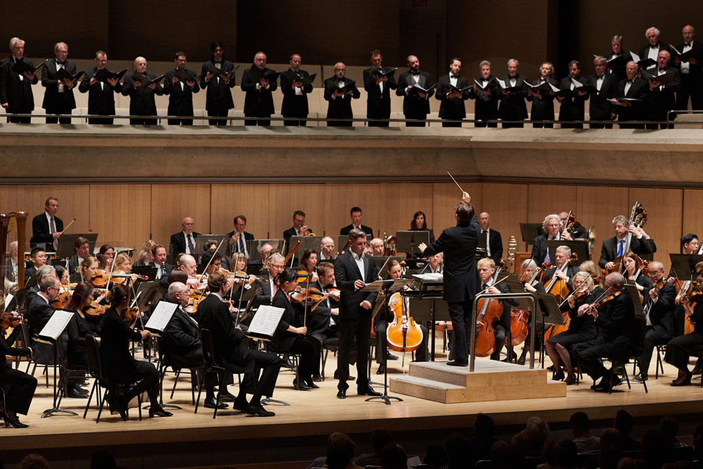 Petr Migunov, Andrey Boreyko, the TSO & Men from the Amadeus Choir and the Elmer Iseler Singers. (Photo: Malcolm Cook)