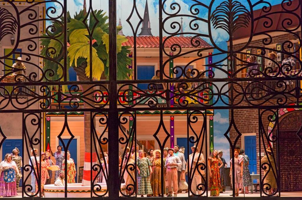 Act II scene featuring a wrought iron gate that is a tribute to renowned Charleston blacksmith, Philip Simmons and members of the cast and chorus. (Photo: Julia Lynn)