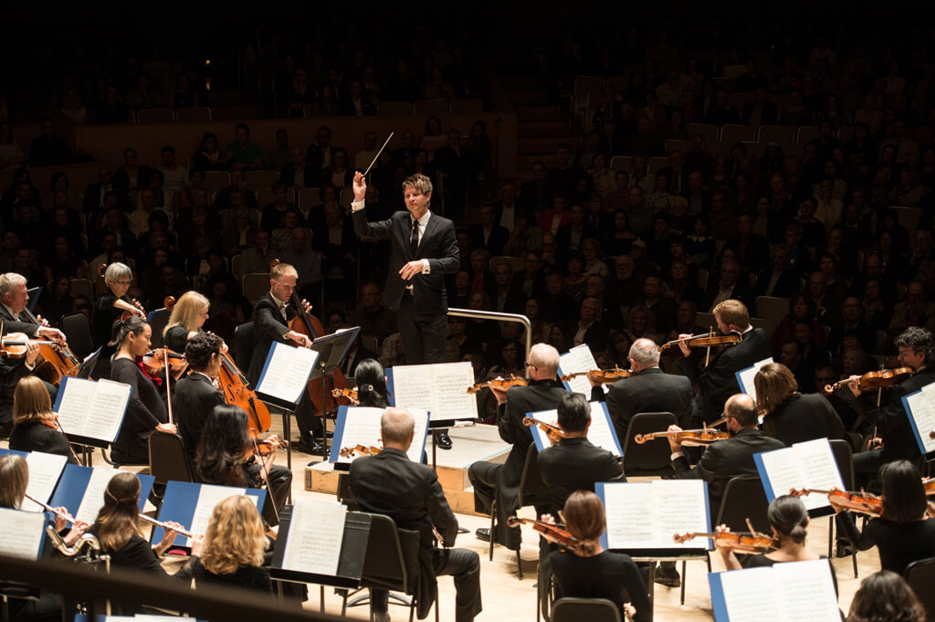 Guest conductor Krzysztof Urbanski with the TSO (Photo: Jag Photography)