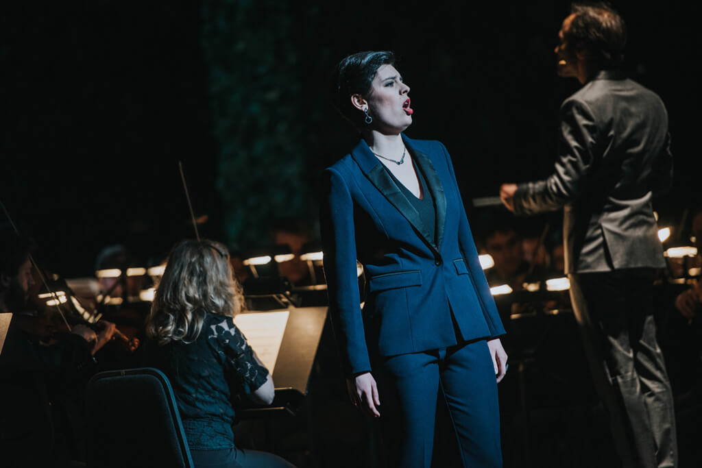 Mezzo-soprano Emily D’Angelo, in a sleek, tux suit, with skull-cropped short hair. (Photo: Gaetz photography)