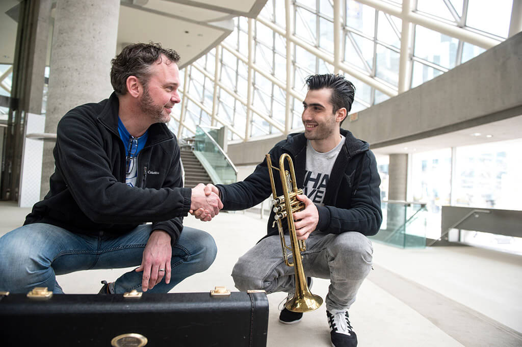 TSO Principal Trumpet Andrew McCandless donates a replacement Trumpet to Syrian musician Abdo Elias (Photo: Jag Gundu)