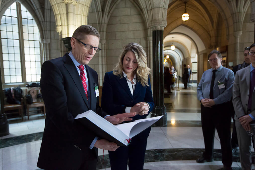 The Toronto Symphony Orchestra presented Heritage Minister Melanie Joly with a book of songs and a CD from last year's Canada Mosaic project, on Parliament Hill in Ottawa, Ontario on Feb 13, 2018. (Photo: David Kawai)