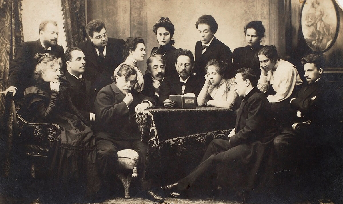 A posed photograph of Anton Chekhov reading his play The Seagull to the Moscow Art Theatre company in 1898 (Public domain)