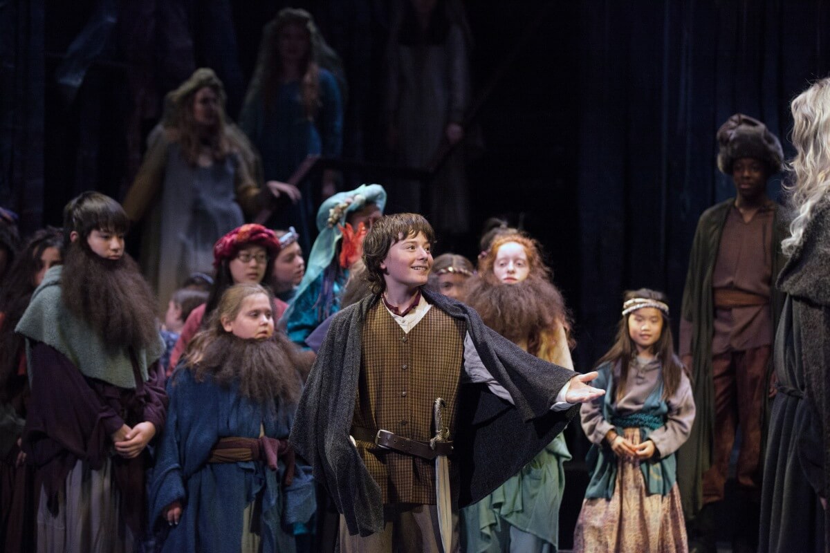 CCOC Principal Chorus member Nicholas Mochocki as Bilbo Baggins, Giles Tomkins as Gandalf, and CCOC choristers in The Hobbit in 2016 (Courtesy of the CCOC)