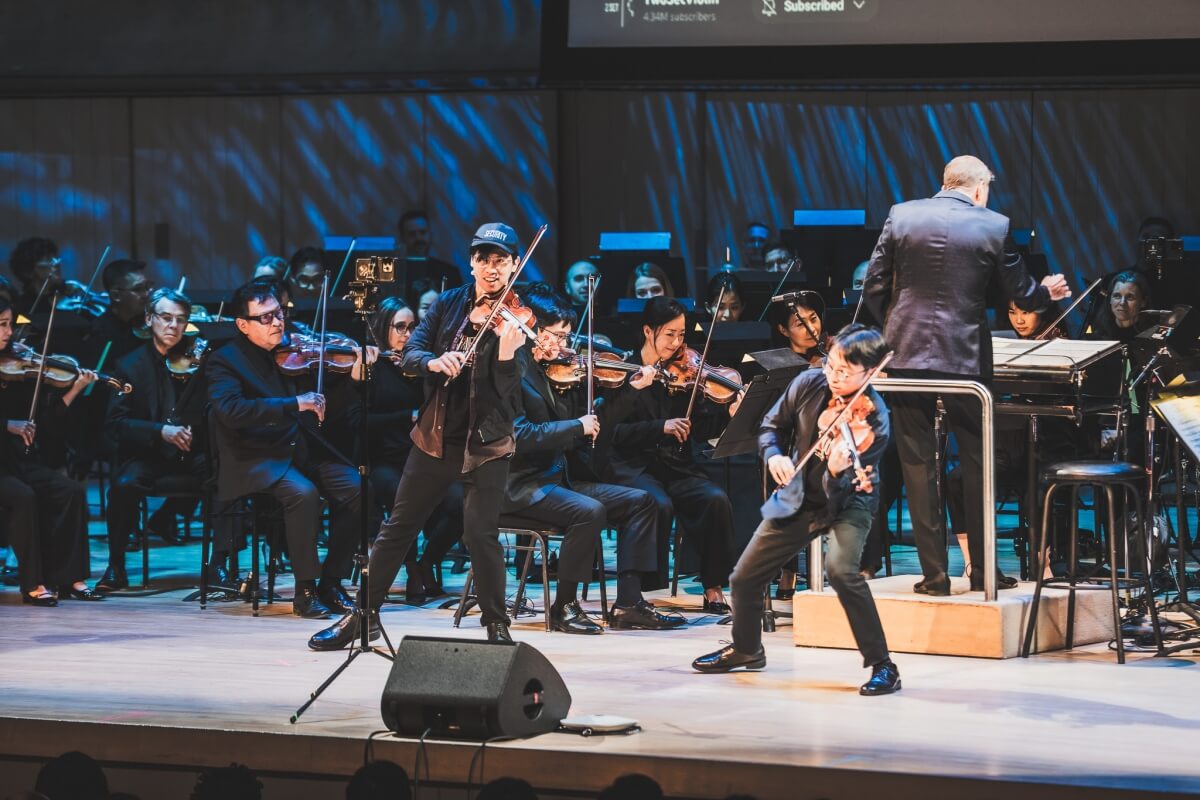 TwoSet Violin perform with the Toronto Symphony Orchestra and conductor Steven Reineke (Photo: Allan Cabral)