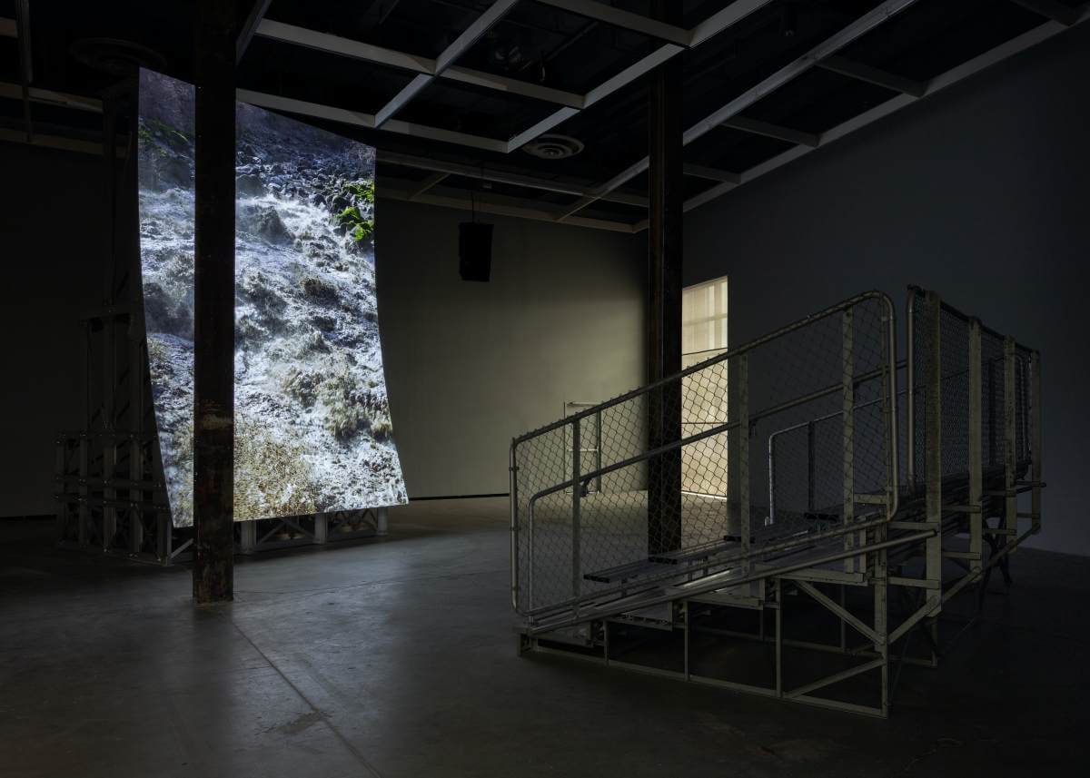 Lucy Raven, Murderers Bar, 2025. Colour video, quadraphonic sound, aluminum andplywood screen, and aluminum seating structure, 41:47. Co-commissioned and jointly acquired by The Vega Foundation and the Vancouver Art Gallery. Courtesy the artist and Lisson Gallery. Installation view: The Power Plant, Toronto, 2025. (Photo: LF Documentation)