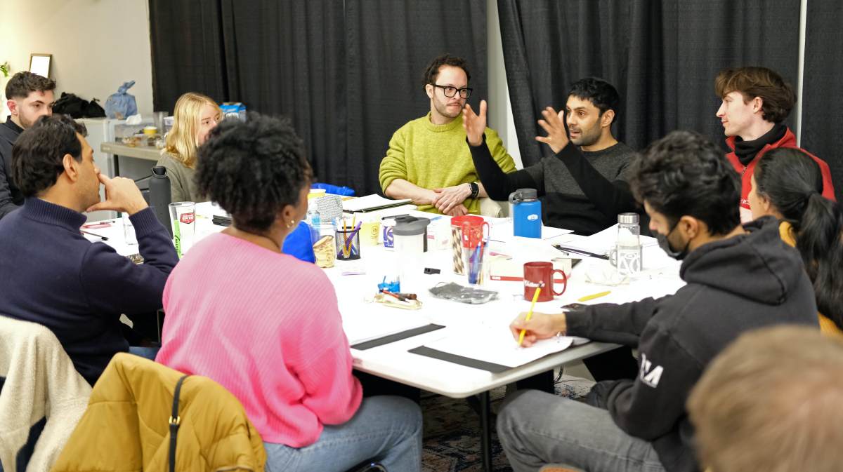 Mohsin Zaidi (centre right, with his hands up) at a table reading for The Surrogate (Photo courtesy of Crow’s Theatre)